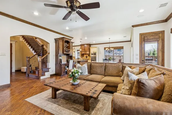 a living room with furniture and wooden floor