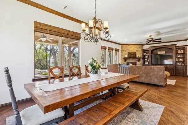 a living room with furniture a chandelier and a dining table