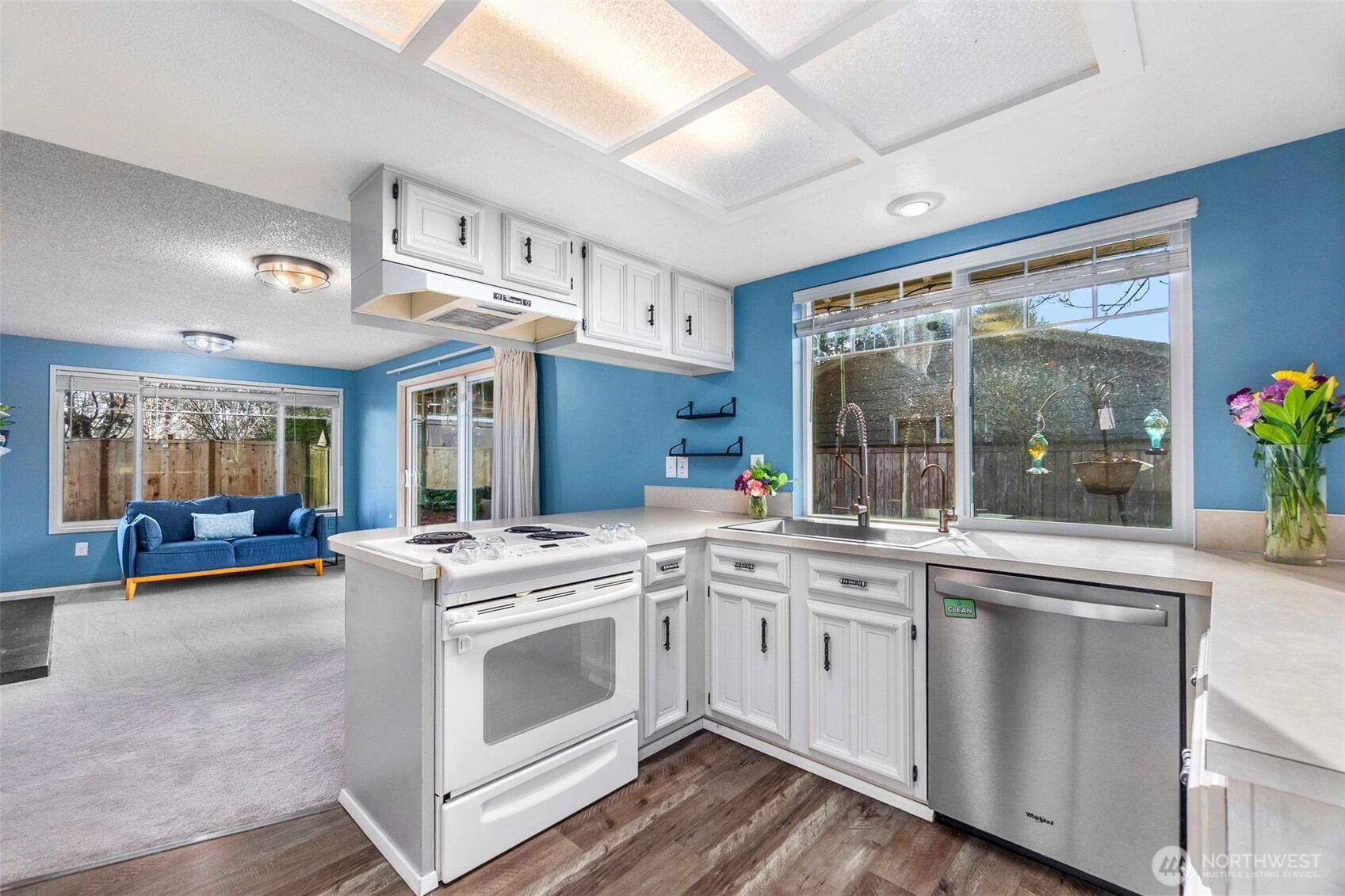 3102 60th Loop Southeast Olympia, WA 98501 - Photo 17 of 40 a view of a kitchen with cabinets and wooden floor