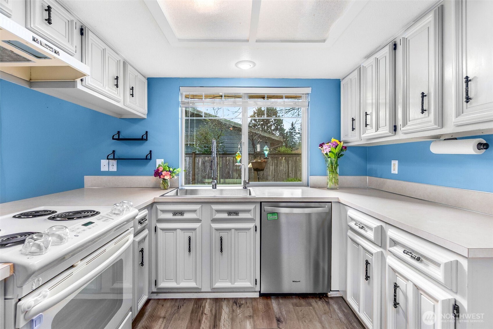 3102 60th Loop Southeast Olympia, WA 98501 - Photo 19 of 40 a kitchen with stainless steel appliances granite countertop a sink and a stove