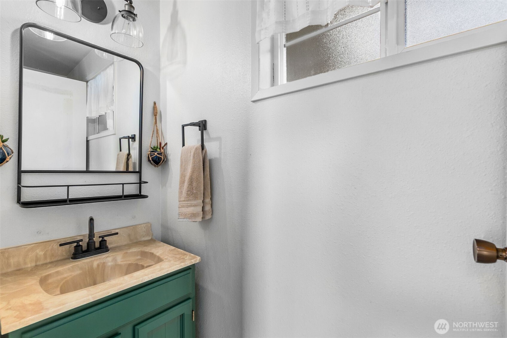 3102 60th Loop Southeast Olympia, WA 98501 - Photo 28 of 40 a bathroom with a sink vanity and mirror