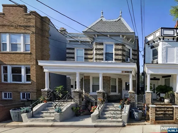 a view of a brick house with many windows
