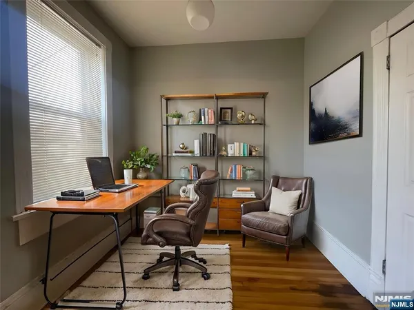 a view of a workspace with furniture and a window