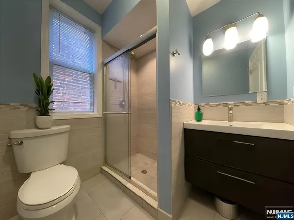 a bathroom with a toilet a sink and glass door