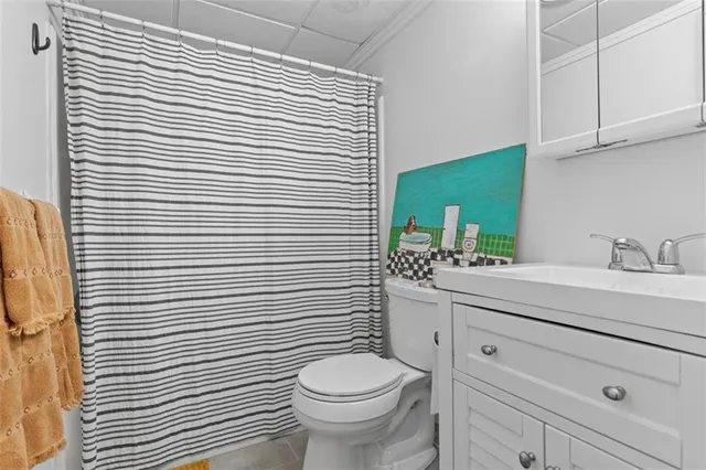 a bathroom with a toilet a sink and mirror