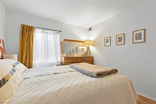 a bedroom with a large bed and a window