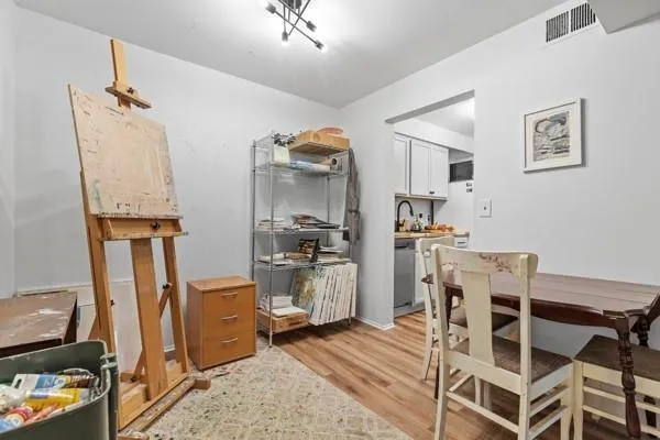 a view of a kitchen with refrigerator and workspace