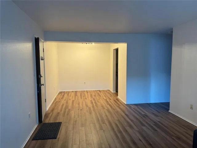 a view of a room with wooden floor and iron gate
