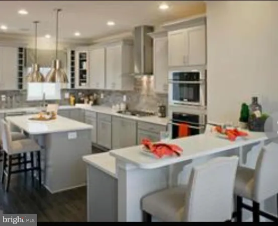 a kitchen with kitchen island a stove a table and chairs