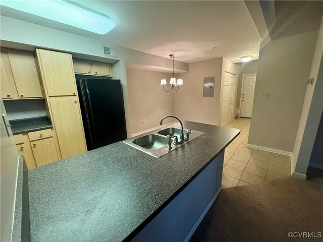 a kitchen with stainless steel appliances granite countertop a sink a refrigerator and a stove