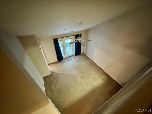 a view of a hallway with stairs