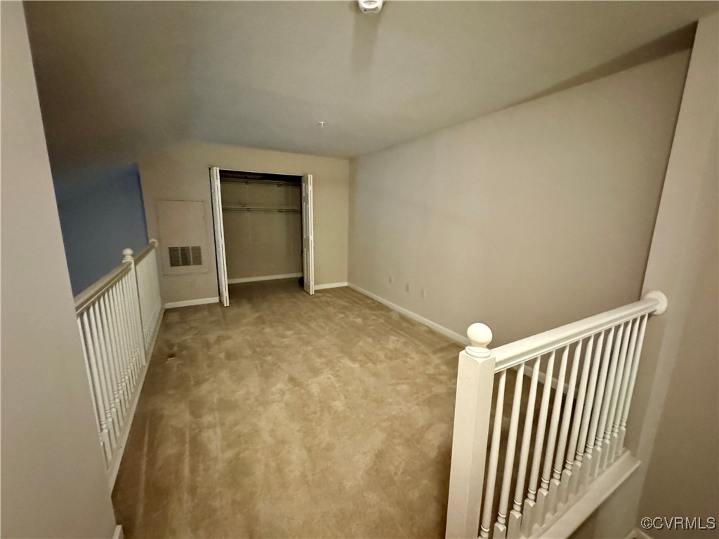 604 Bristol Village Drive, Unit 303 Midlothian, VA 23114 - Photo 14 of 18 an empty room with a staircase