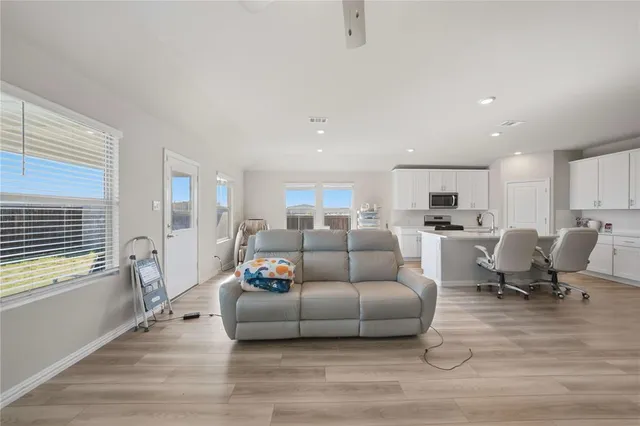 a living room with furniture and a wooden floor