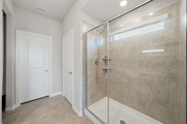 a bathroom with a glass shower door