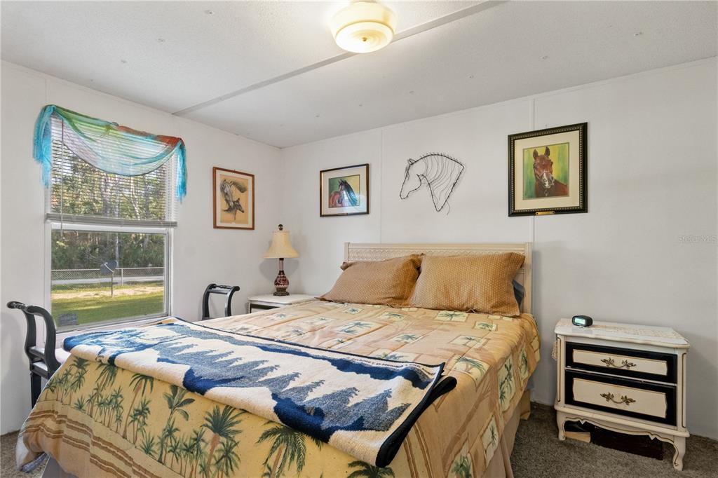 3650 176 Place Inglis, FL 34449 - Photo 26 of 49 a bedroom with a bed and a painting on the wall