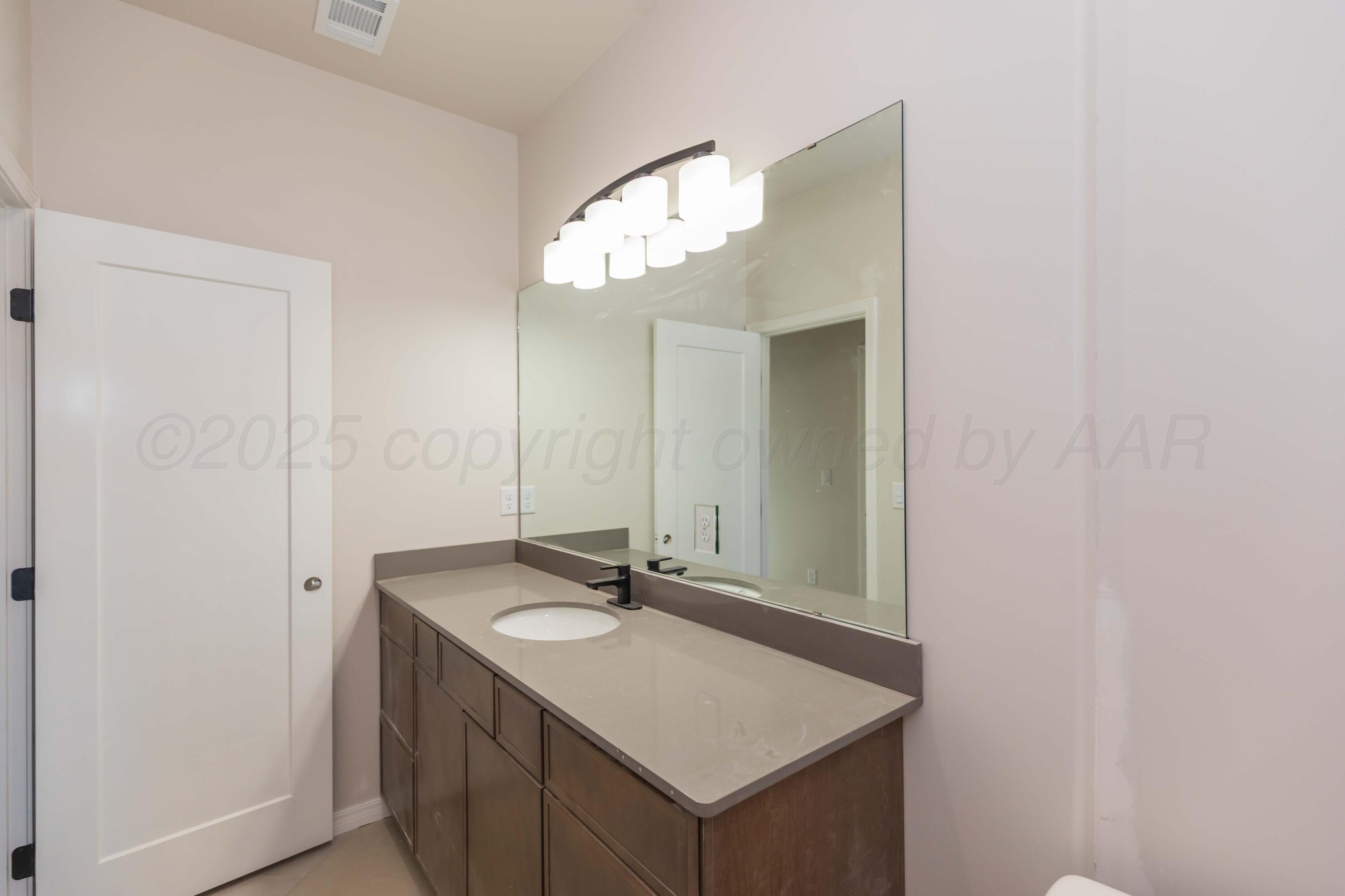 1205 Cabernet Way Amarillo, TX 79124 - Photo 12 of 13 a bathroom with a sink and a mirror
