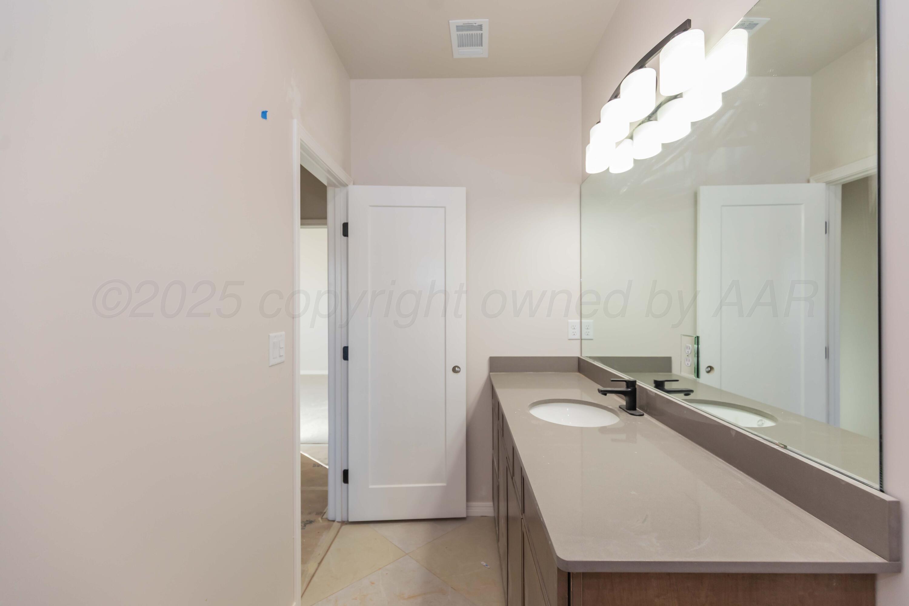 1205 Cabernet Way Amarillo, TX 79124 - Photo 13 of 13 a bathroom with a sink a mirror and shower