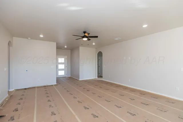 a view of a big room with a chandelier fan