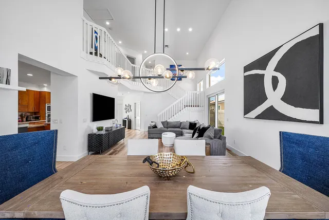 a kitchen with stainless steel appliances kitchen island granite countertop a sink a stove a table and chairs