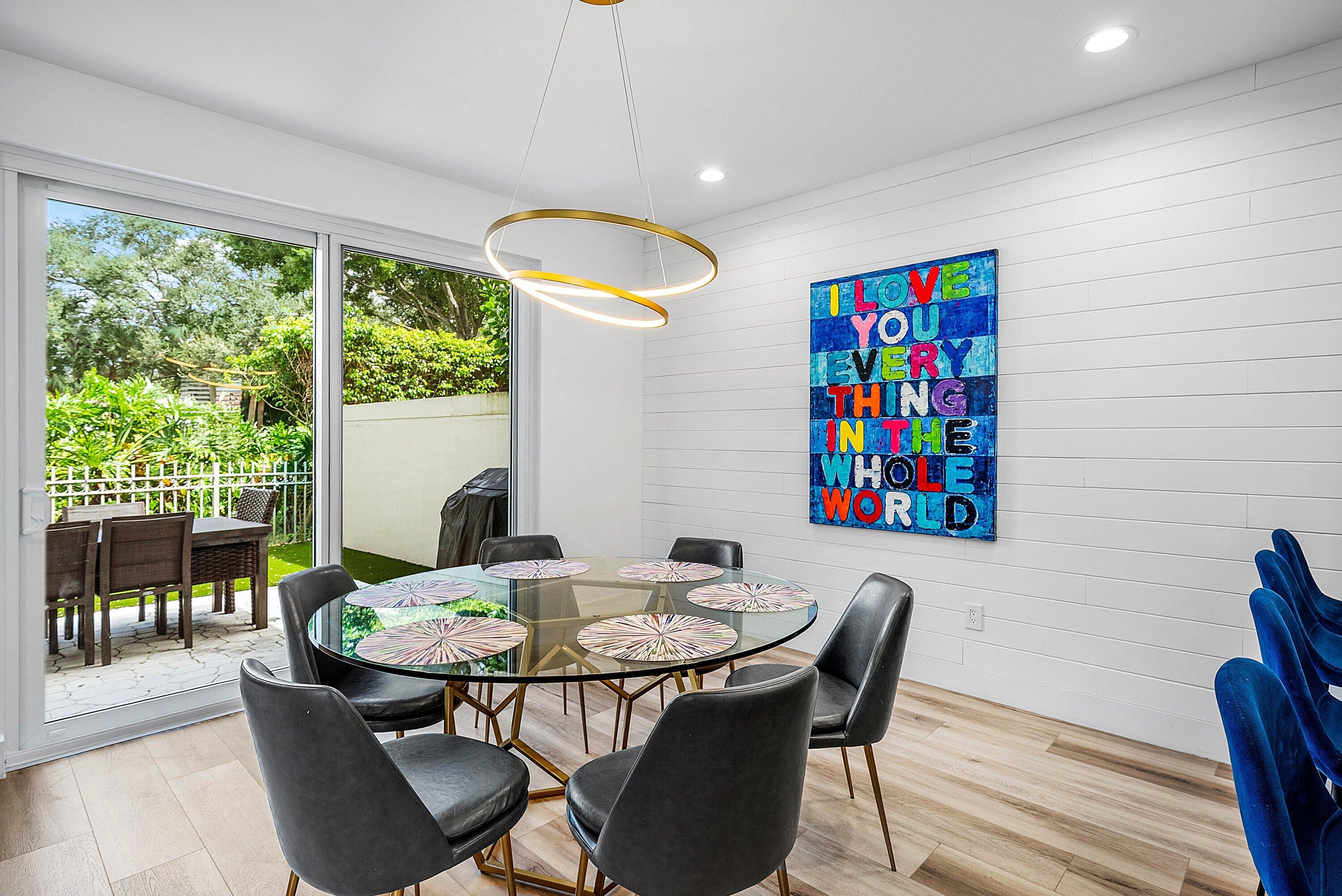 5338 Northwest 26th Circle Boca Raton, FL 33496 - Photo 12 of 68 a view of a dining room with furniture wooden floor and a chandelier