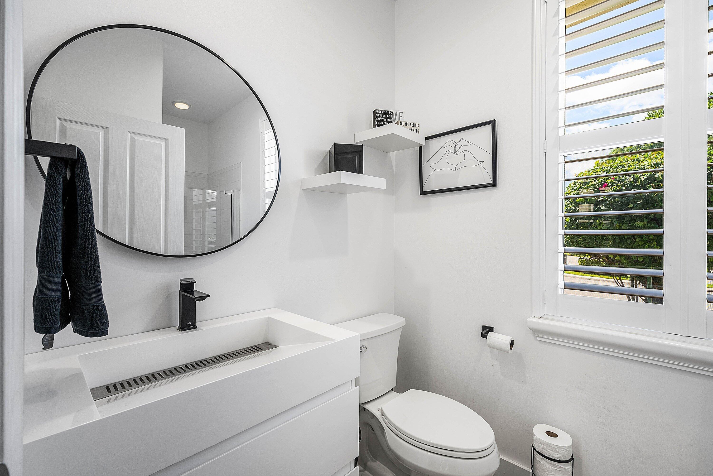 5338 Northwest 26th Circle Boca Raton, FL 33496 - Photo 20 of 68 a bathroom with a toilet a sink and a mirror