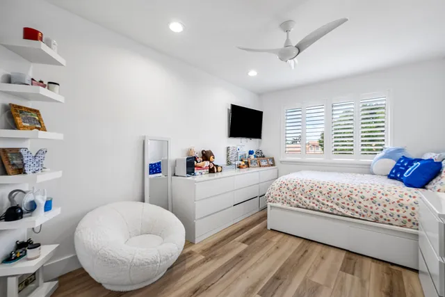 a view of a dining room with furniture and a potted plant