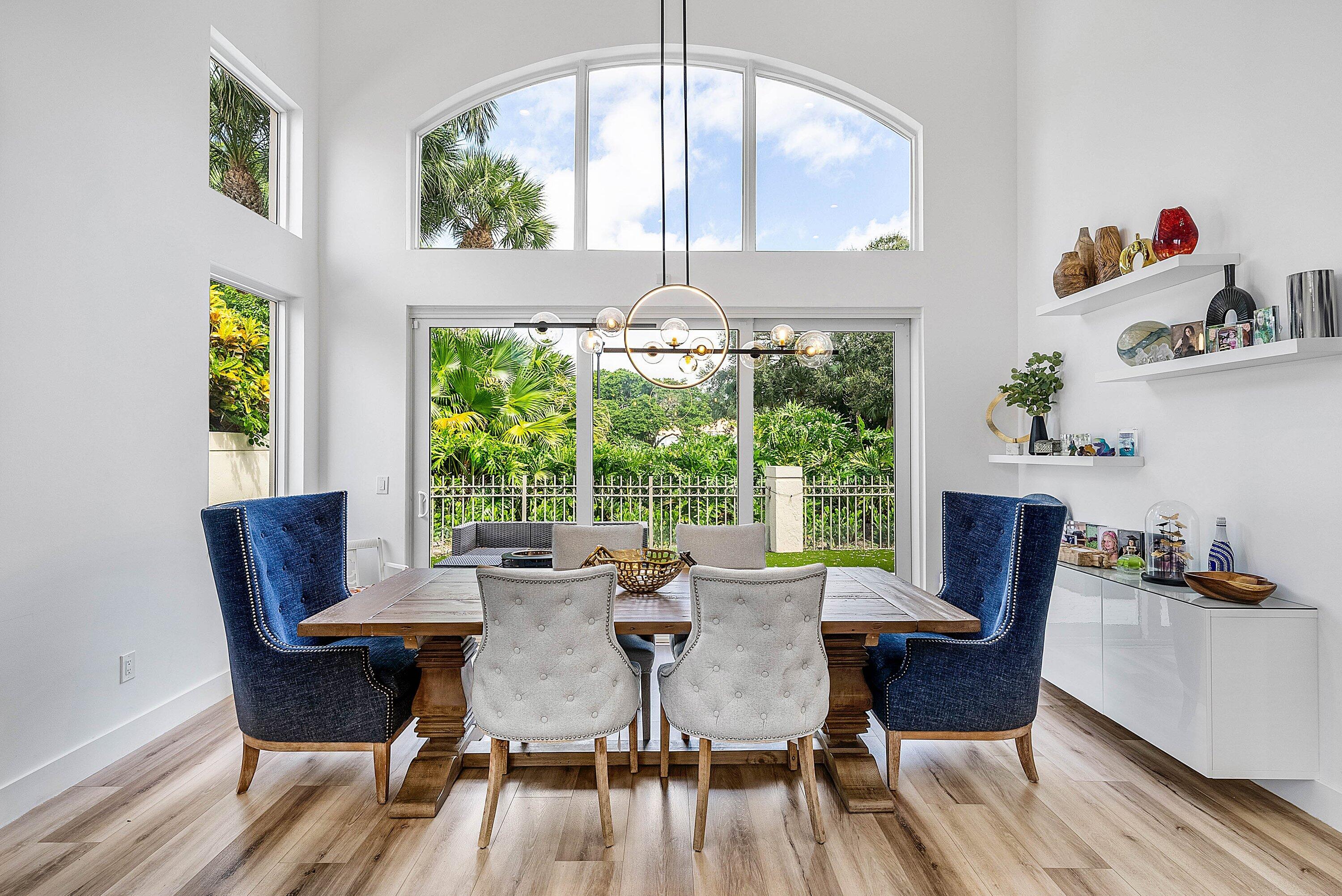 5338 Northwest 26th Circle Boca Raton, FL 33496 - Photo 10 of 68 a view of a dining room with furniture a chandelier and wooden floor