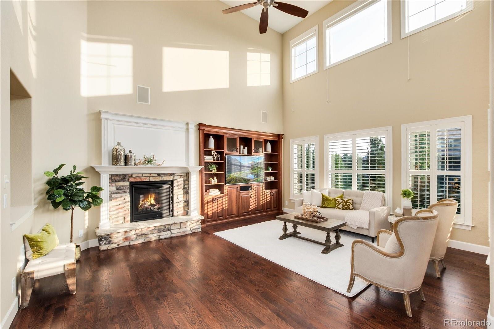 470 Maplehurst Drive Highlands Ranch, CO 80126 - Photo 19 of 40 a living room with furniture and a fireplace
