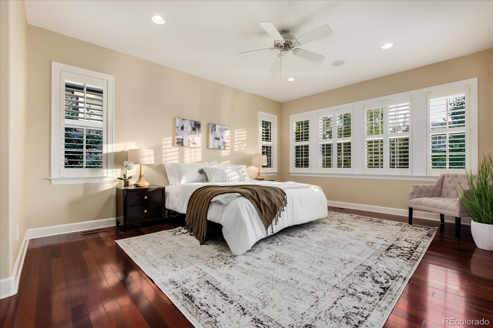 470 Maplehurst Drive Highlands Ranch, CO 80126 - Photo 21 of 40 a bedroom with a large bed and wooden floor