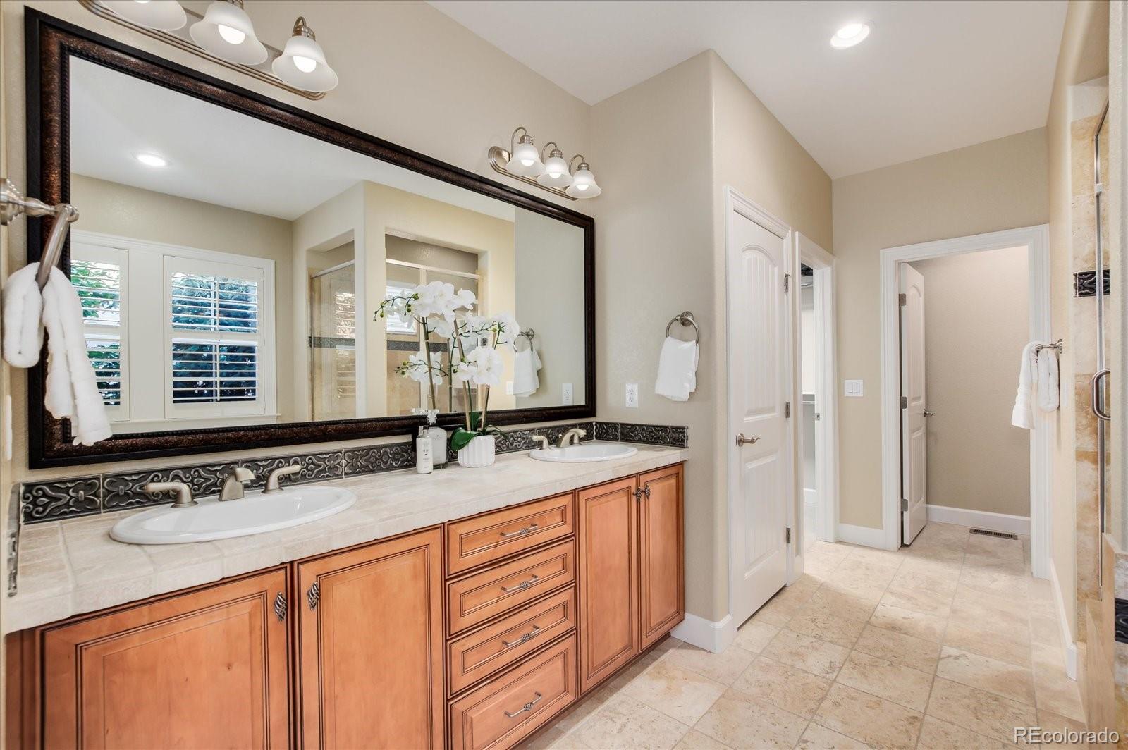 470 Maplehurst Drive Highlands Ranch, CO 80126 - Photo 22 of 40 a bathroom with double sink and a mirror