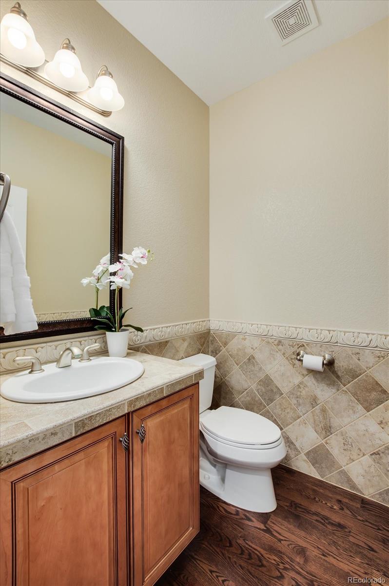 470 Maplehurst Drive Highlands Ranch, CO 80126 - Photo 25 of 40 a bathroom with a granite countertop sink a toilet and a mirror