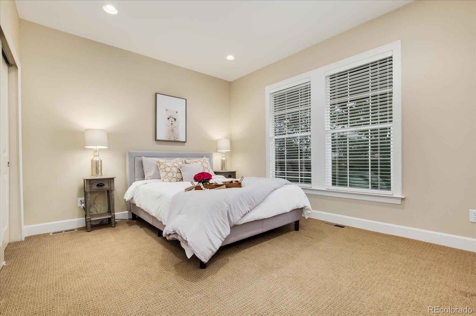 470 Maplehurst Drive Highlands Ranch, CO 80126 - Photo 26 of 40 a bed sitting in a spacious bedroom next to a window