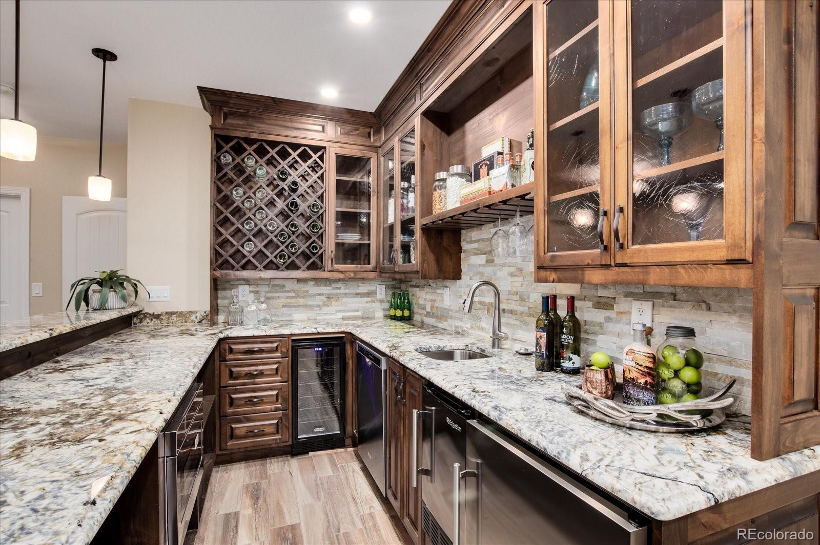 470 Maplehurst Drive Highlands Ranch, CO 80126 - Photo 28 of 40 a kitchen with granite countertop lots of counter space and wooden floor