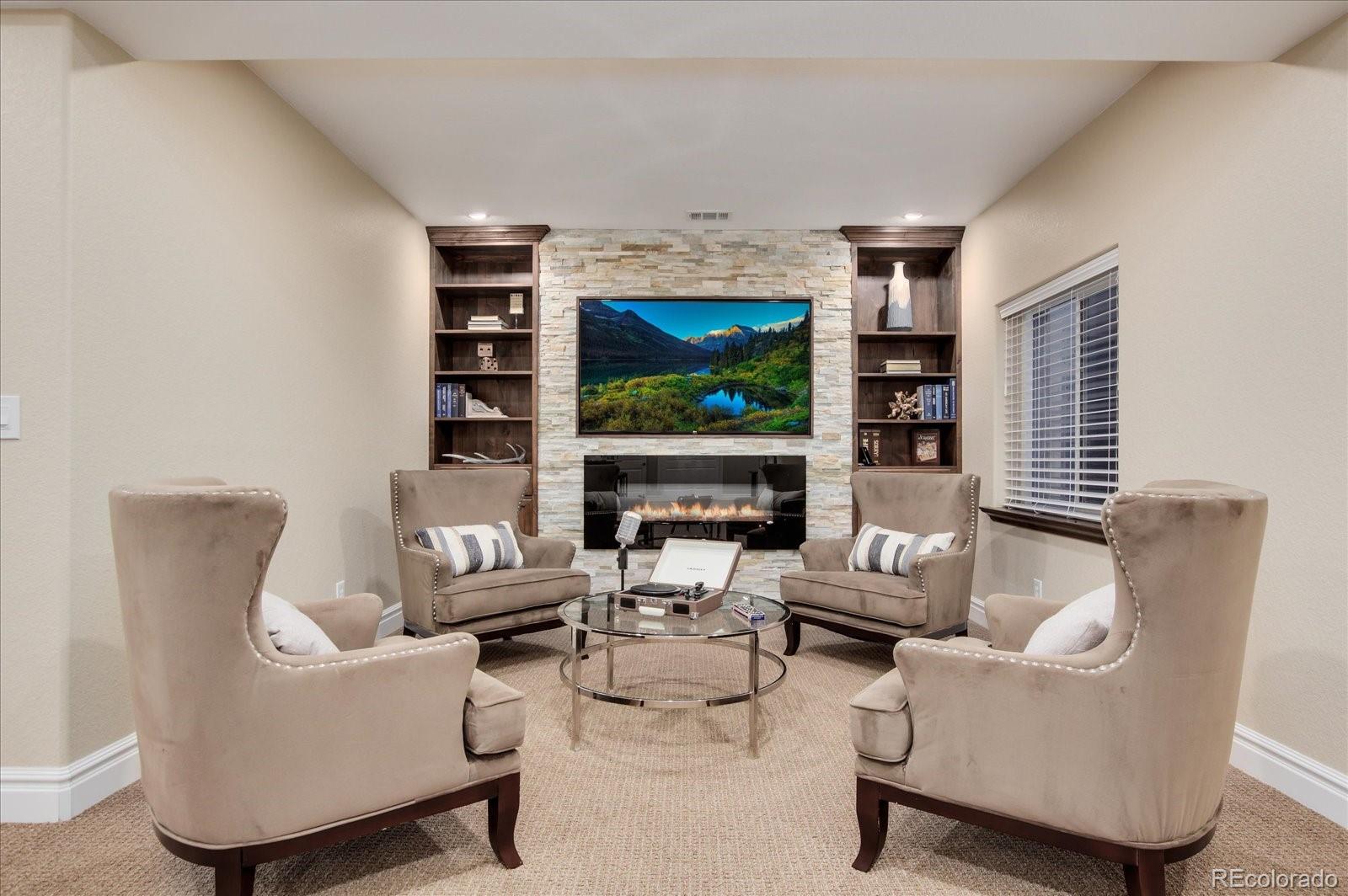 470 Maplehurst Drive Highlands Ranch, CO 80126 - Photo 29 of 40 a living room with furniture a projector and a flat screen tv
