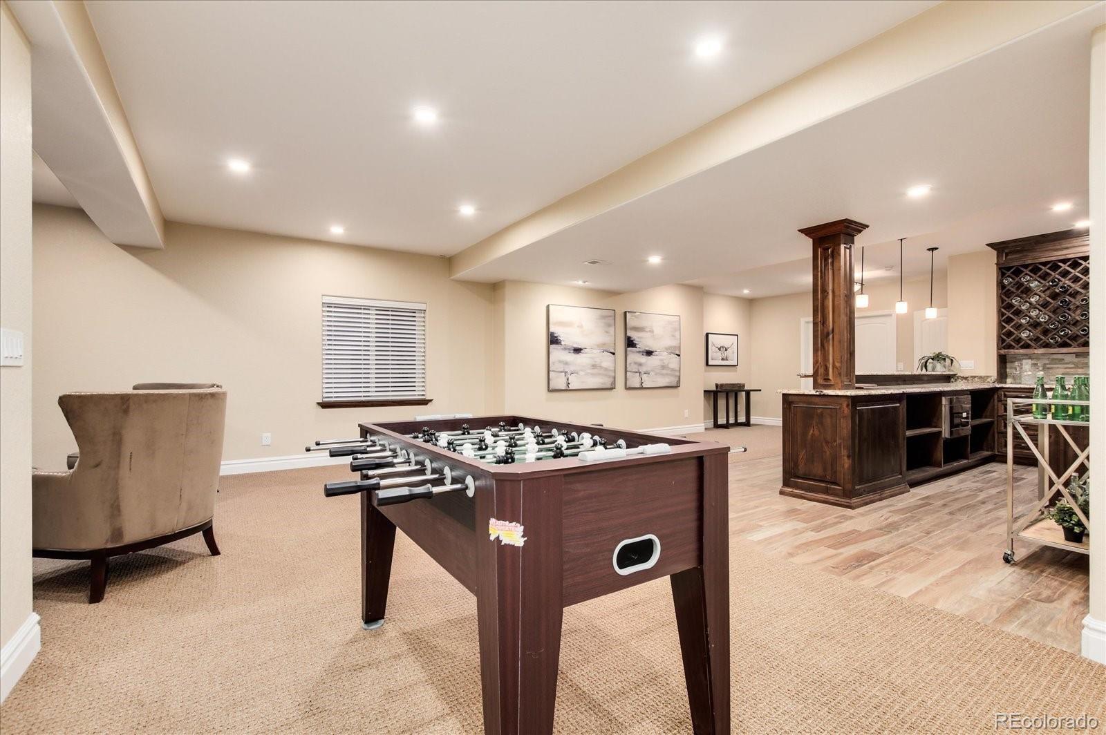 470 Maplehurst Drive Highlands Ranch, CO 80126 - Photo 30 of 40 a kitchen with stainless steel appliances granite countertop a stove a sink a refrigerator and a microwave