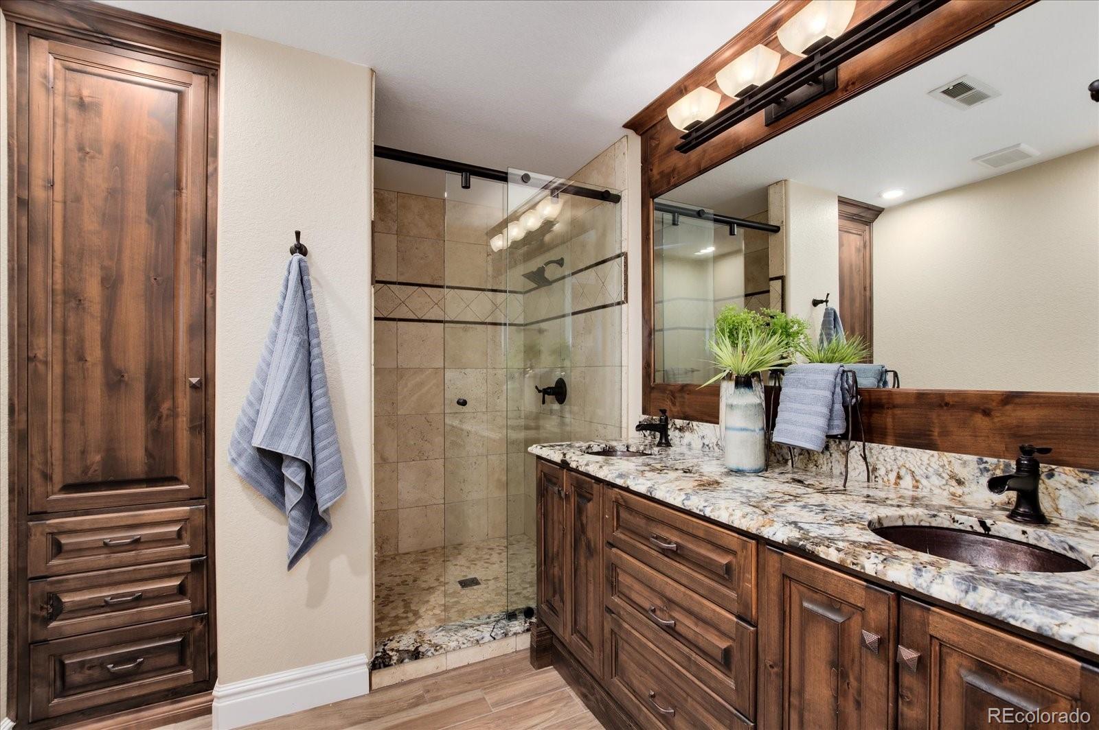470 Maplehurst Drive Highlands Ranch, CO 80126 - Photo 31 of 40 a bathroom with a granite countertop sink and a mirror