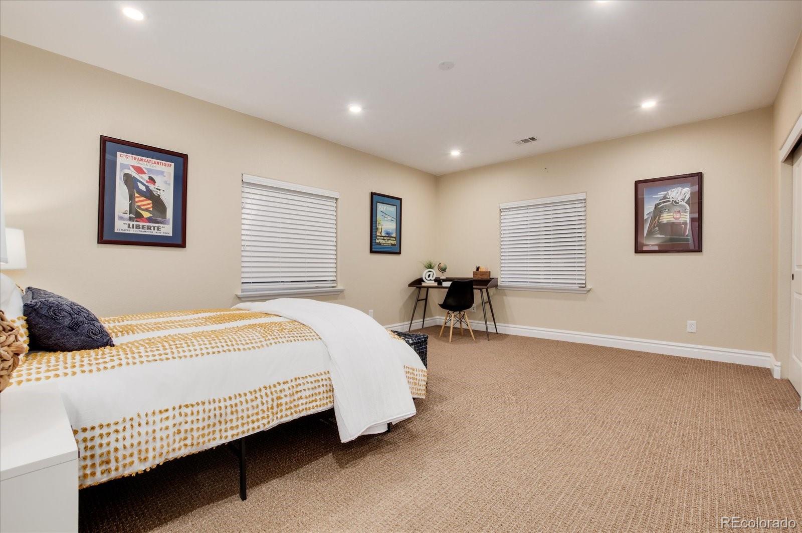 470 Maplehurst Drive Highlands Ranch, CO 80126 - Photo 32 of 40 a bedroom with a bed and a couch