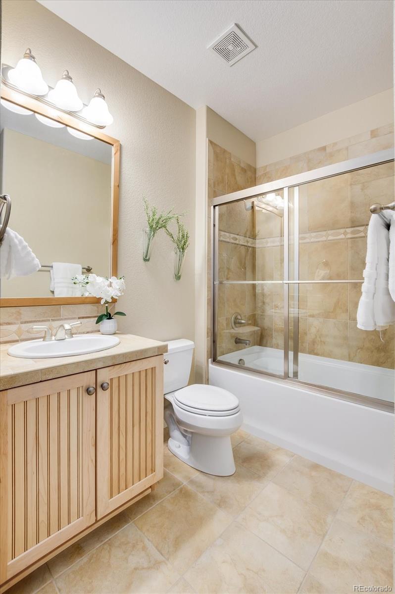 470 Maplehurst Drive Highlands Ranch, CO 80126 - Photo 34 of 40 a bathroom with a toilet a sink and a large mirror