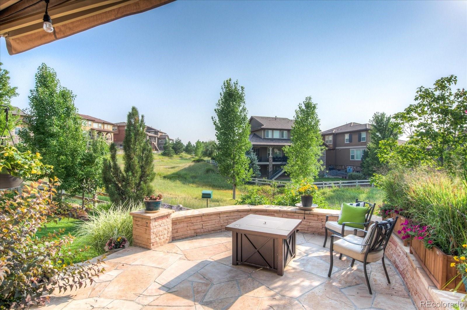 470 Maplehurst Drive Highlands Ranch, CO 80126 - Photo 35 of 40 a view of a patio with couches table and chairs and potted plants