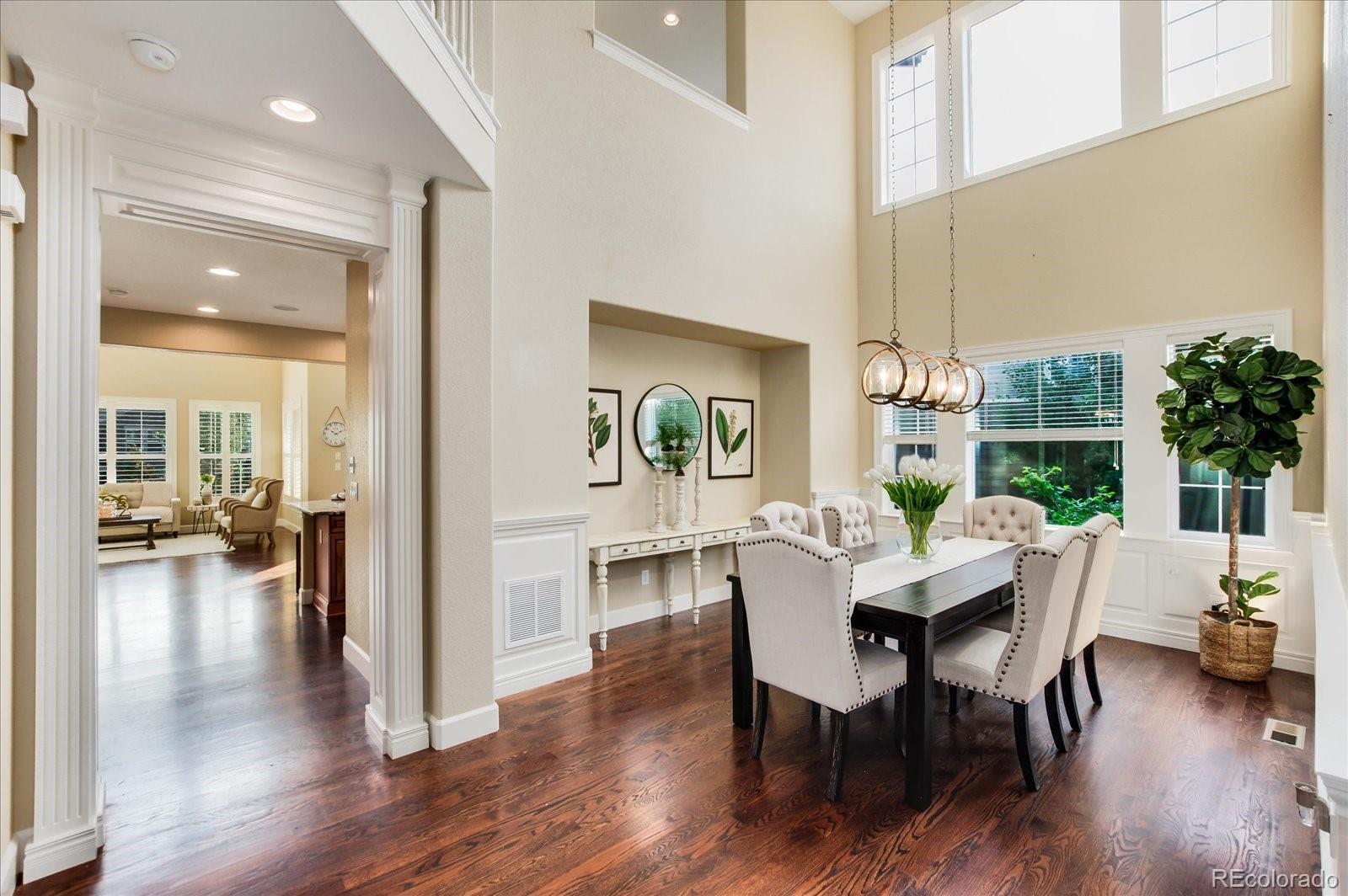 470 Maplehurst Drive Highlands Ranch, CO 80126 - Photo 9 of 40 a view of a dining room with furniture window and wooden floor