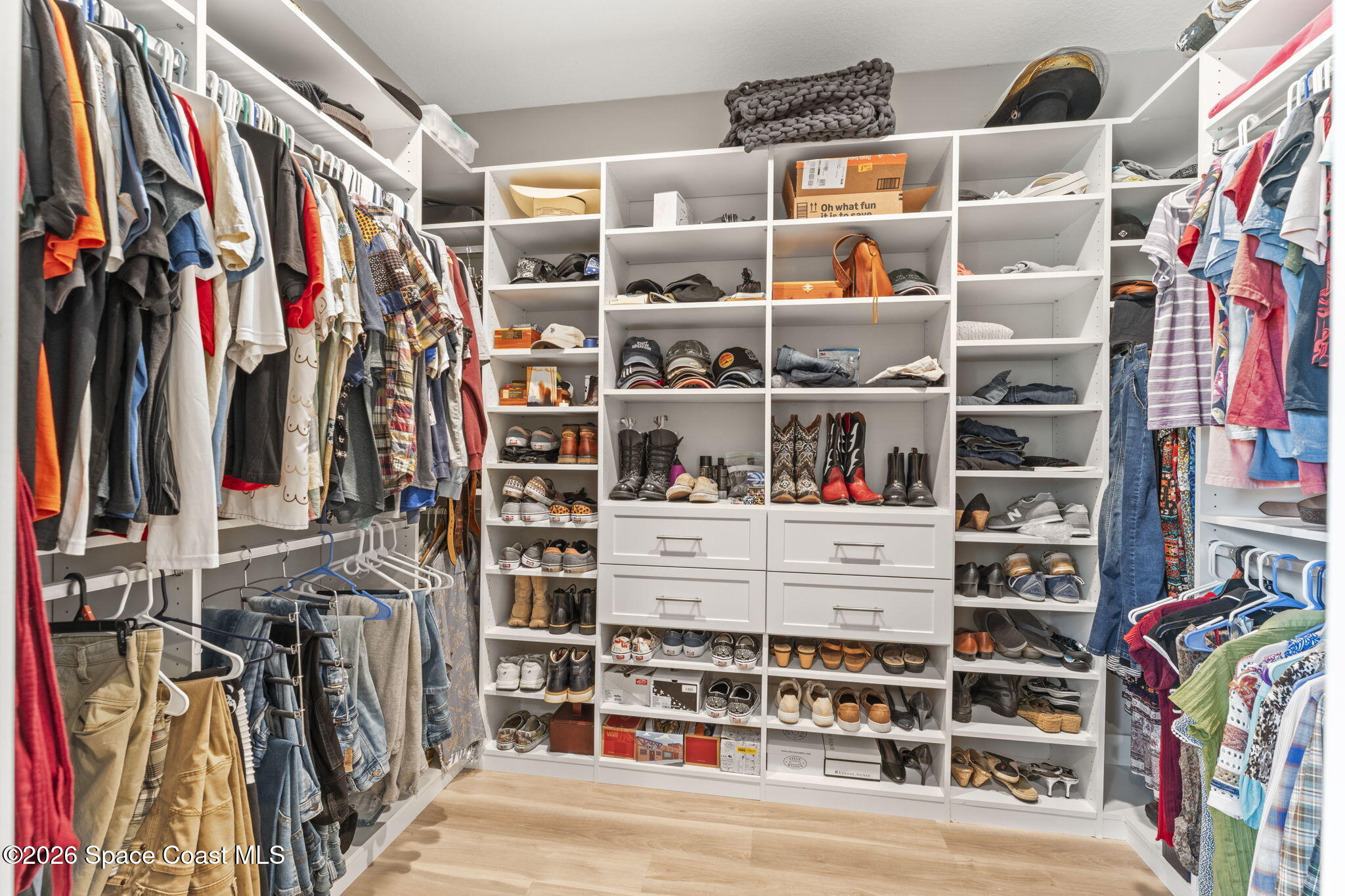 1740 Ford Road Mims, FL 32754 - Photo 23 of 43 a view of walk in closet with clothes and shoes