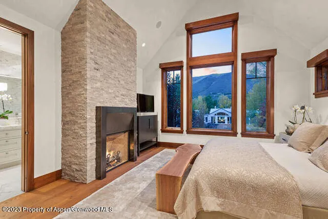a bedroom with a bed and a fireplace