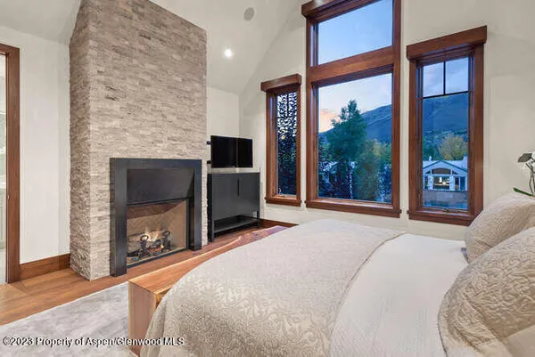 a bedroom with a bed and a fireplace