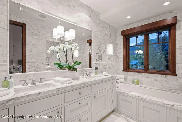 a bathroom with a sink and a large mirror