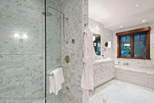 a bathroom with a double vanity sink toilet mirror and bathtub