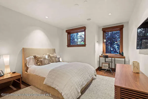 a bedroom with a bed a table and chair