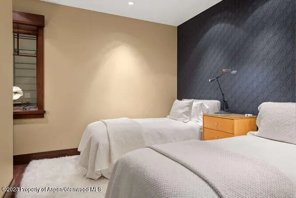 a bedroom with a bed and a night stand