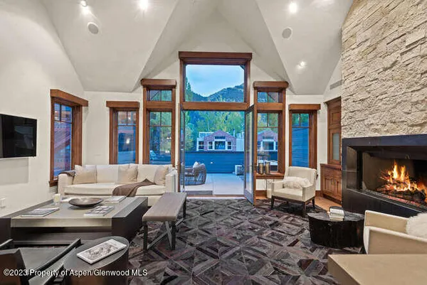 a living room with furniture a fireplace and a flat screen tv