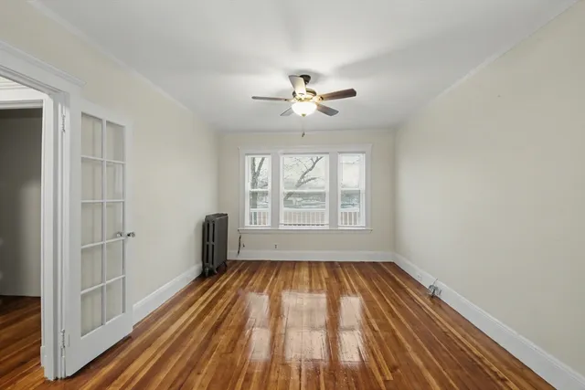 wooden floor in an empty room with a window