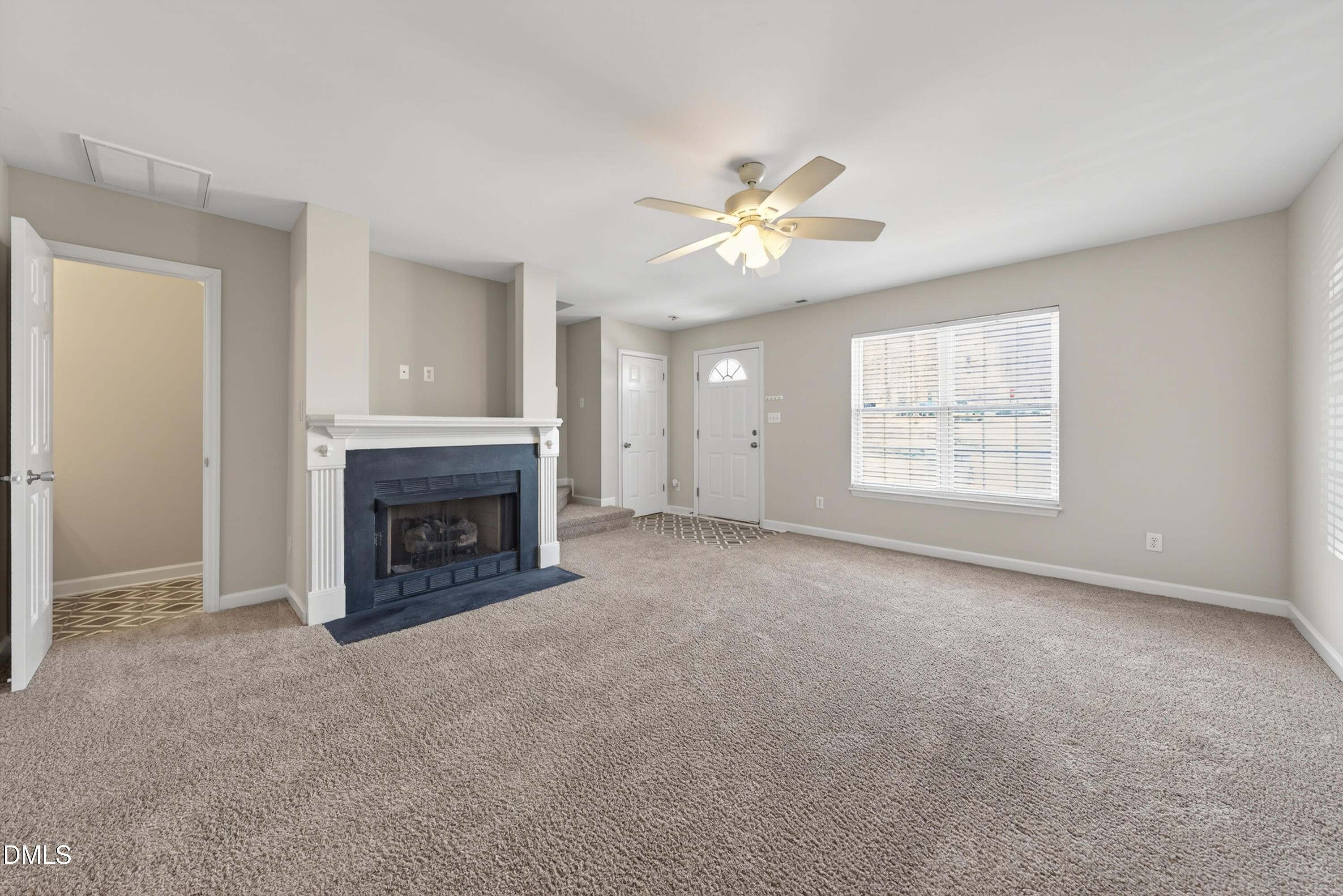 1601 Briarmont Court Raleigh, NC 27610 - Photo 6 of 30 an empty room with windows and fireplace